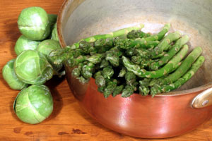 copper cookware and green vegetables